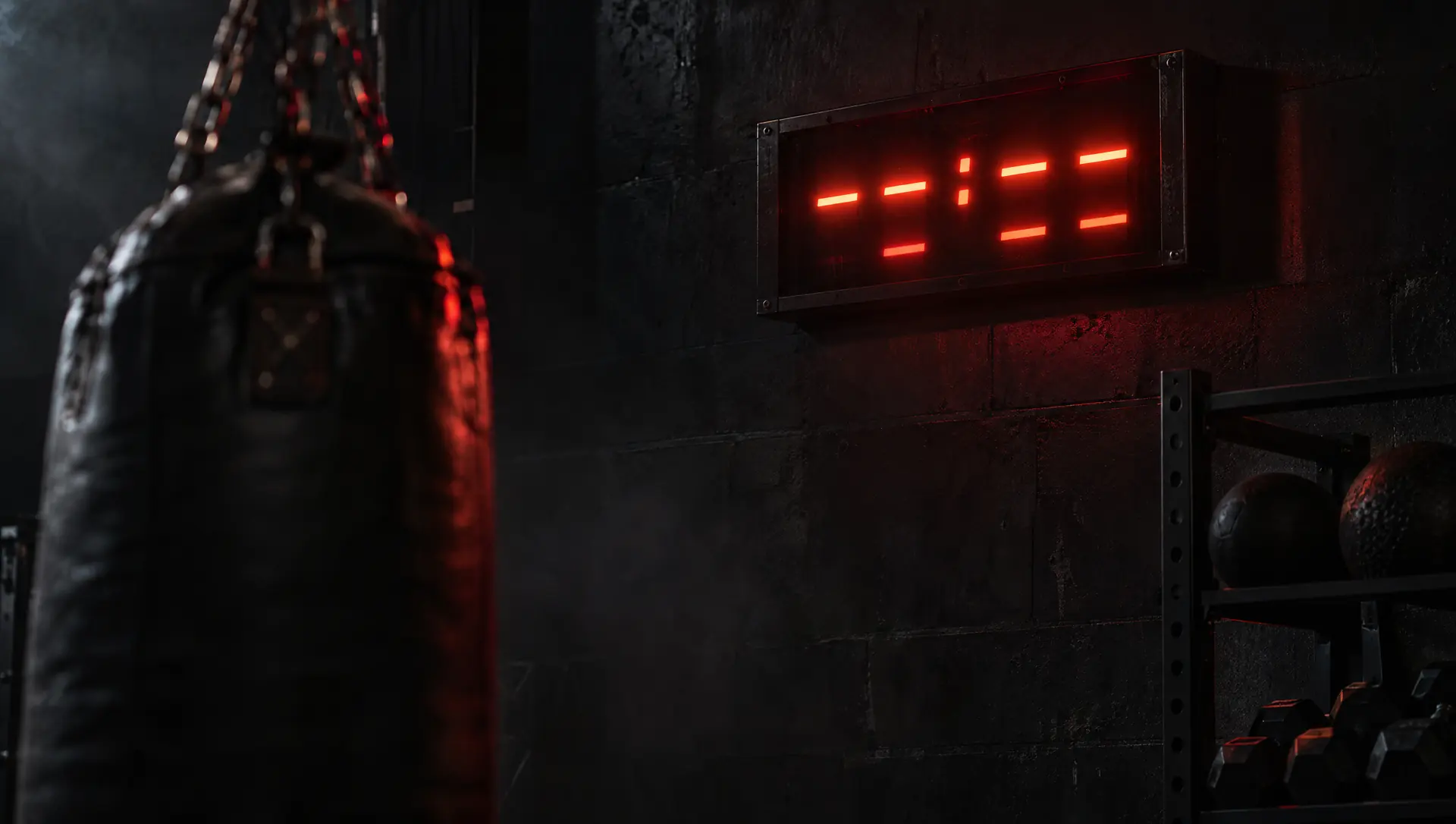 A red interval timer glowing on a gym wall beside a heavy bag.